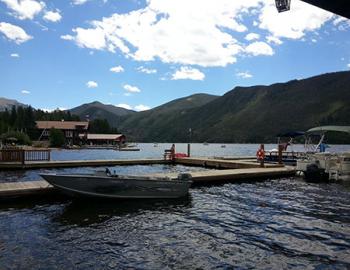 Motorboat and pontoon at a dock.