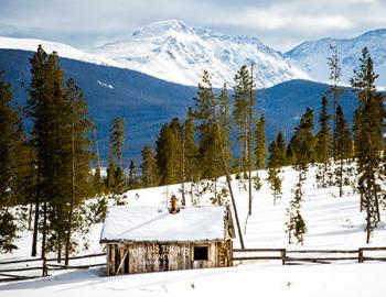 Devil's Thumb Ranch shack and Rocky Mountains.