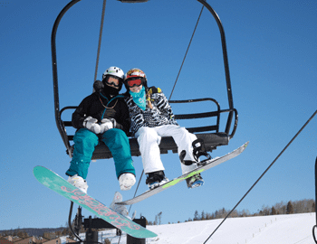 Couple on a ski chairlift.