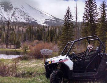 ATV rider near a lake.