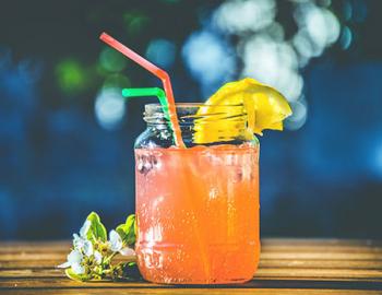 Mixed drink in a mason jar.